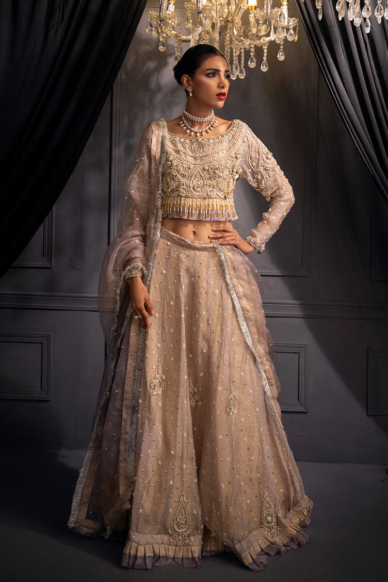Lilac Lumière luxury designer ensemble in soft lilac shimmer organza, featuring a pearl and crystal embellished blouse with an elegant flowing lehenga silhouette.