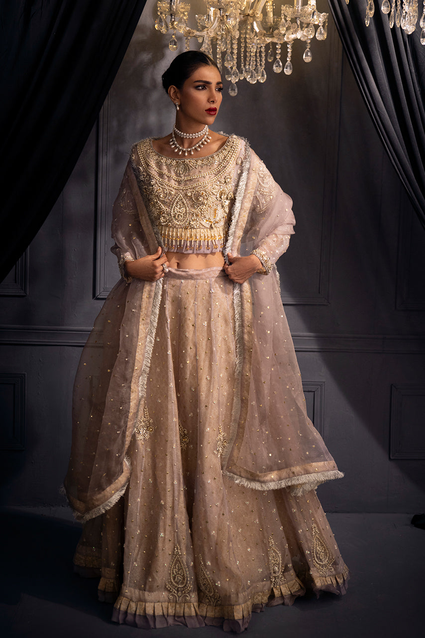 Modern bride reception wear Lilac Lumière designer lehenga set in soft lilac, featuring a delicately embellished organza dupatta, luminous pearl accents and a sweeping couture silhouette.