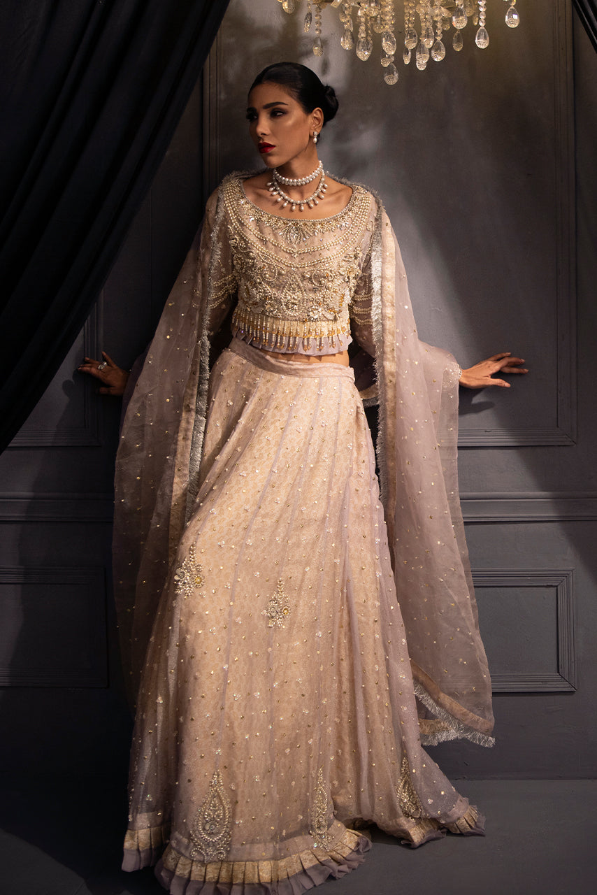 Pastel lilac couture lehenga with handcrafted pearl and crystal embroidery, blending modern elegance with timeless bridal style.