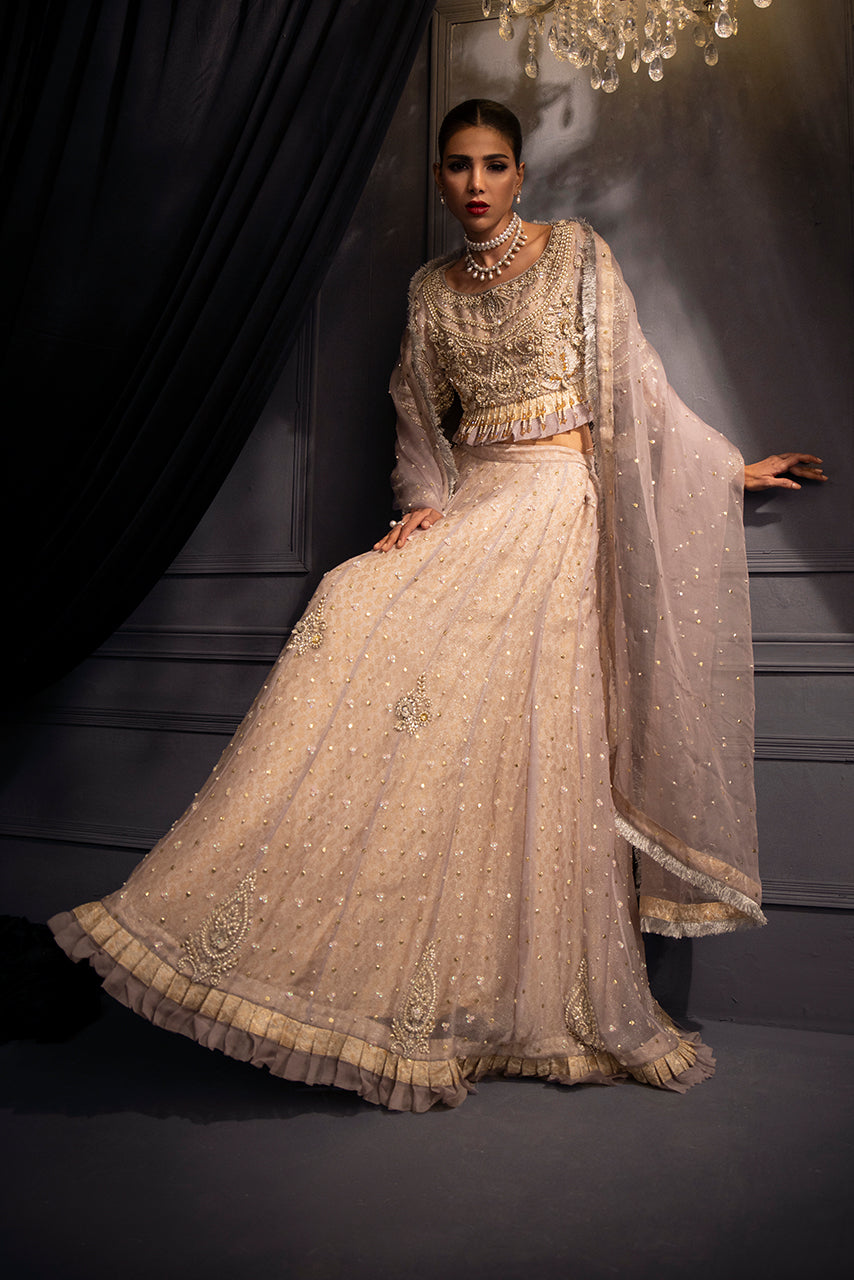 Soft lilac designer lehenga by Lilac Lumière showcasing a graceful flare, embellished border and refined couture craftsmanship