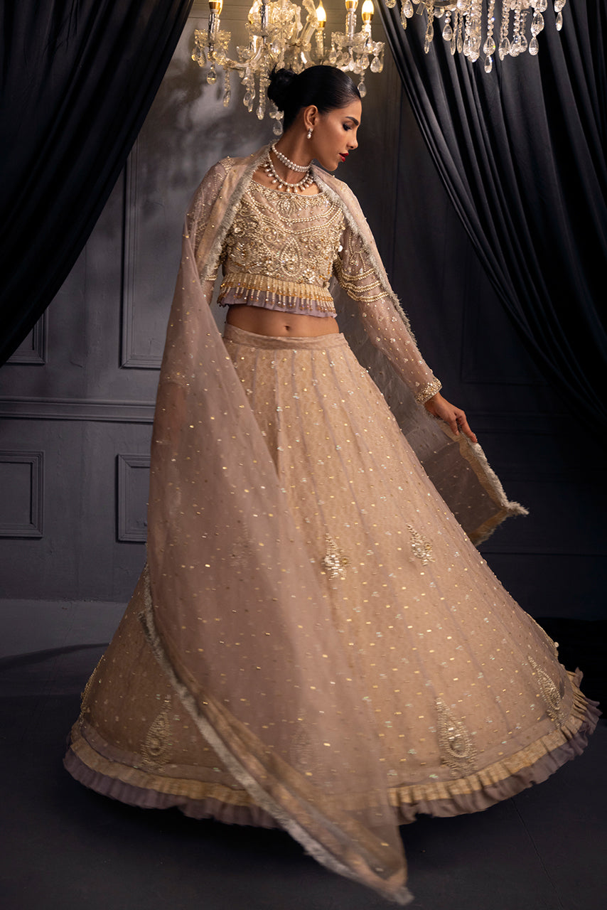 Lilac Lumière pastel lilac couture lehenga has a fluid, sweeping flare, luminous embellishments and a refined embroidered border for an elegant designer finish.