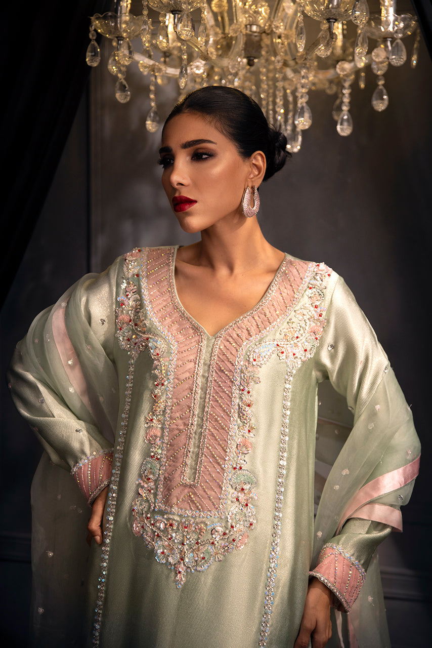 Detailed view of luxury Pakistani formal dress with pink embroidered panel, floral beadwork and handcrafted embellishments on mint silk fabric

