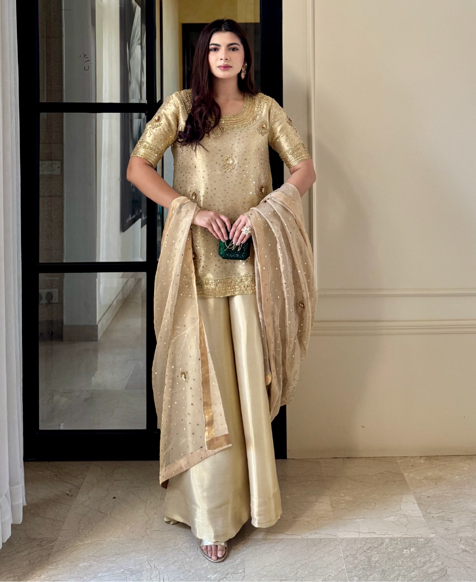 Embroidered formal gharara set in lama tissue with flowing silhouette and detailed dupatta
